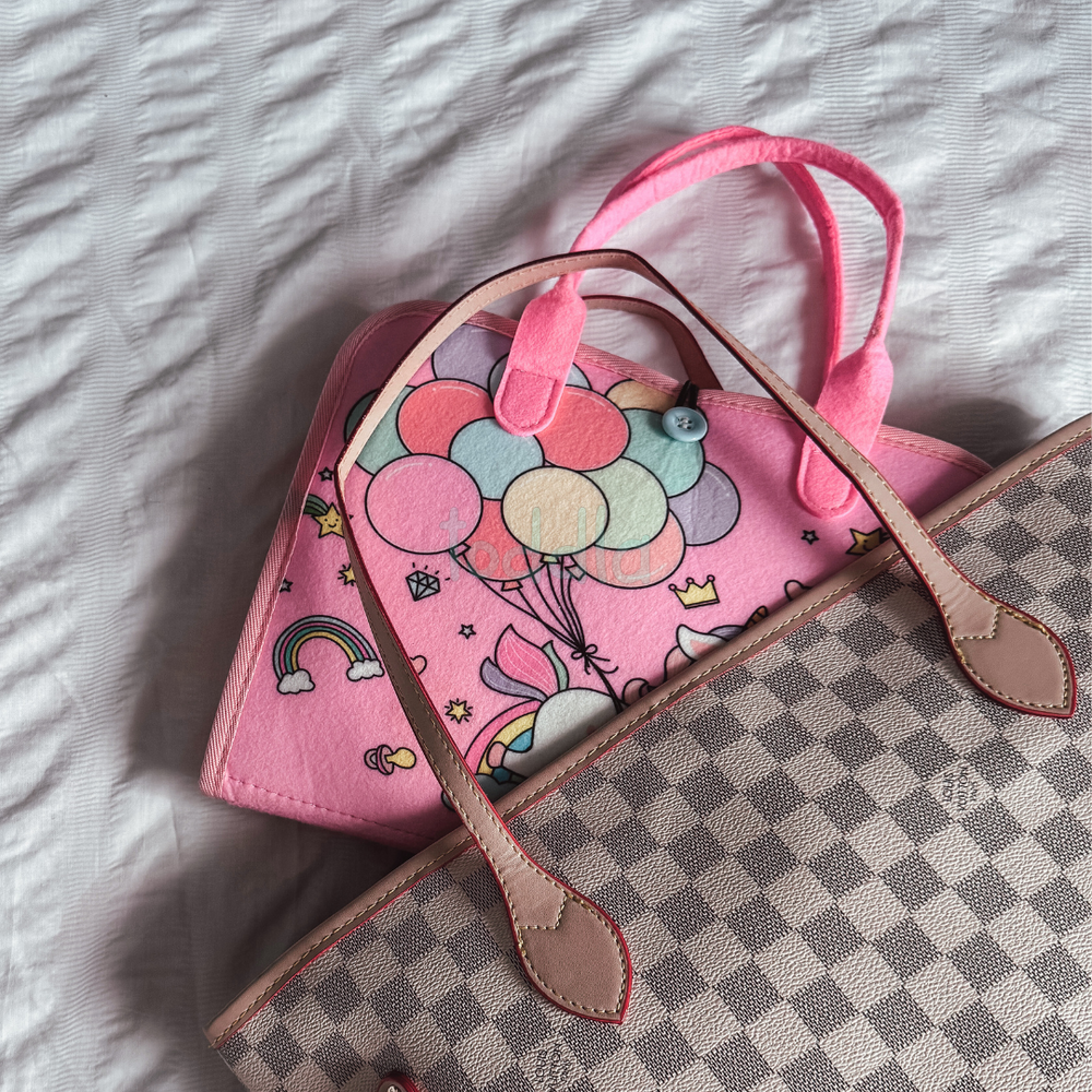 Folded busy board fitting inside a diaper bag
